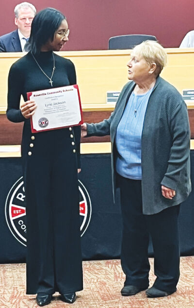  Roseville Middle School eighth grade student Lyric Jackson, left, was recognized for her poem “Released from the Shadows” during Zonta International’s 2024 “Zonta Says No to Violence” online summit. Roseville Community Schools Board of Education President Theresa Genest, right, presents her with a certificate. 