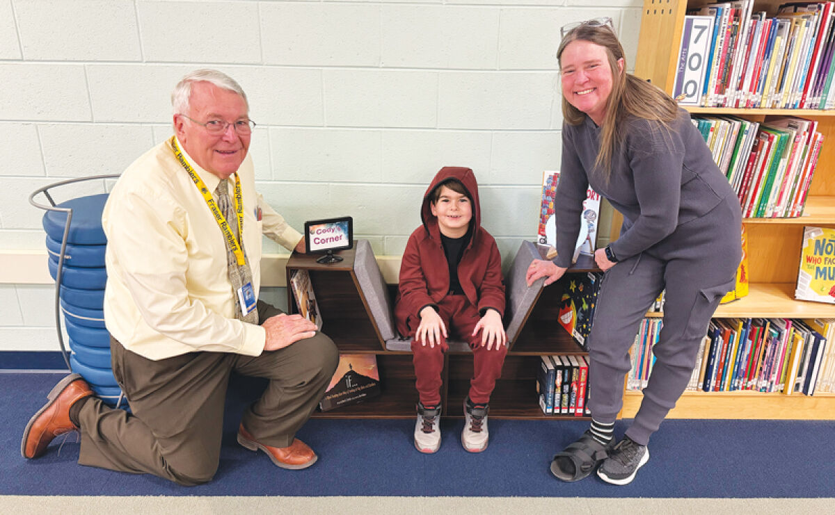  Rick Repicky, interim principal, and librarian Jennifer Barozzini stand with Cody Conser-Quarterman at his corner. 