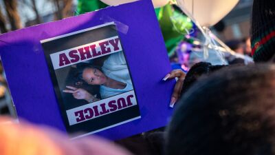  A sign supporting justice for Ashley Elkins is held in the air at a vigil in her memory on Saturday, Jan. 25, in Roseville. 