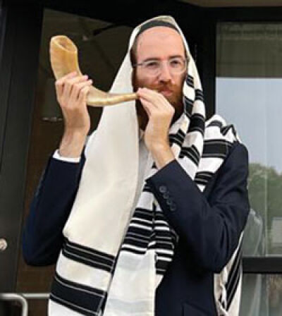  Rabbi Moishie Glitsenstein blows the shofar, an instrument played in the lead-up to Rosh Hashanah, outside the Royal Oak Chabad Jewish Center. 