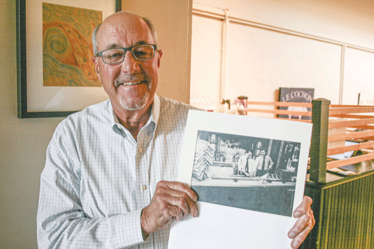  Business owner Gary Kosch holds up an old picture of himself and his brother, Gordie. In 1981, the two brothers founded Kosch’s Korner Deli in Sterling Heights, which lasted until the late 1990s. 
