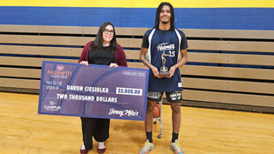  Clintondale counselor Courtney Carroll and award winner Davon Ciesiolka posing with the Jersey Mike’s check and the Courage award. 