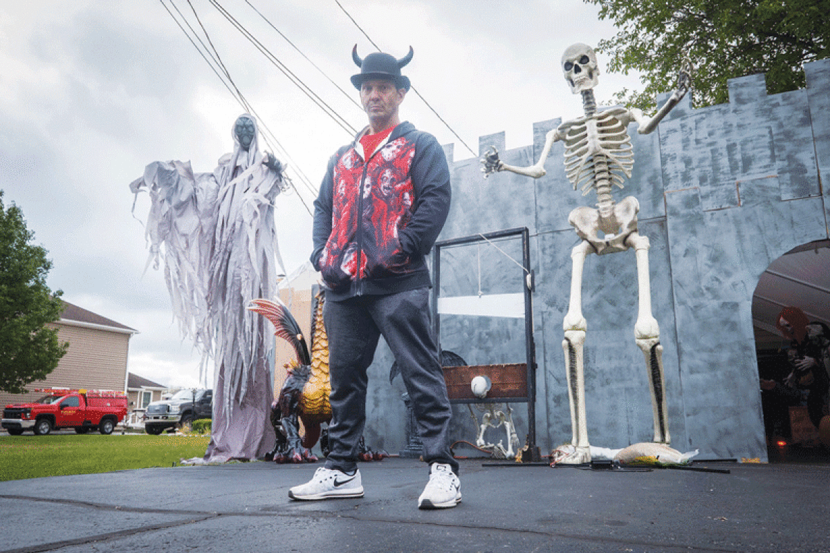  Jeff Wirick poses for a portrait outside  the haunted house he constructs each year  in Harrison Township. 