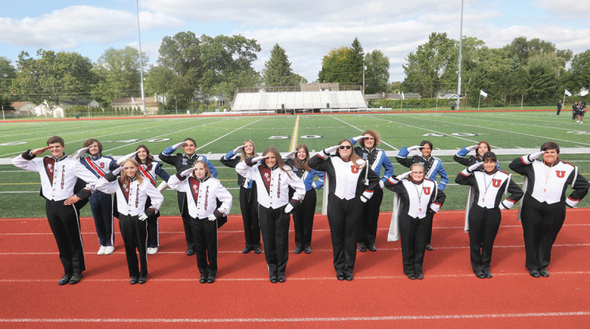  Drum majors from the four Utica Community Schools marching bands salute during a promotional event for Band-A-Rama at Swinehart Field in Shelby Township Sept. 29. In the front row, from left, representing Henry Ford II High School are James Velasco, Emma Hildebrand, Margaret Johnson and Jenna Burton, and representing Utica High School are Maia Suggs, Emma Phillips, Lila Sapiano and Chloe Fashho. In the back row, from left, representing Stevenson High School are Braden Cook and Chloe Zaharof, and representing Eisenhower High School are Ethan Delbeke, Cayla Colby, Rosaria Serraiocco, Ian Garden, Divya Bartley and Kenzie Mazzola. 