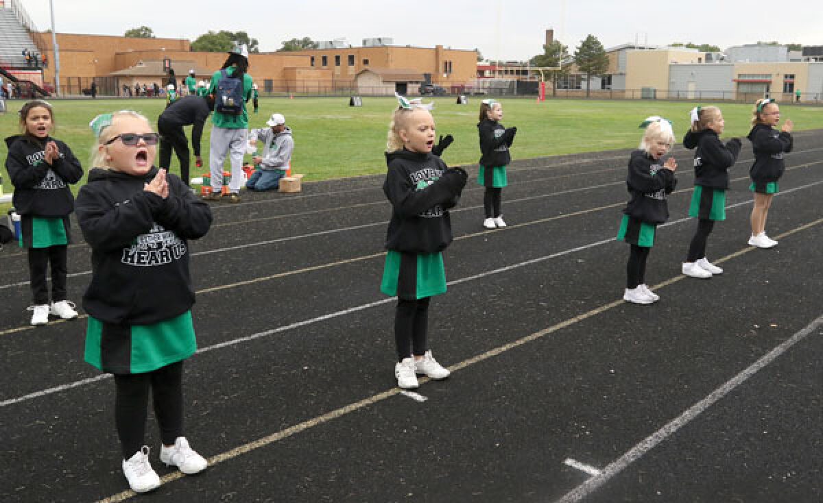  The St. Clair Shores Green Hornets cheerleaders showcase their moves as the football team takes on the Warren Jets on Sept. 24 at Warren Lincoln High School. 